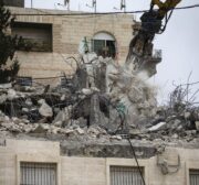 Israeli-run Jerusalem Municipality team along with Israeli soldiers and bulldozers demolish the house owned by a disabled Palestinian Hatim Abu Rayala (R), near the al-Issawiya neighborhood claiming that it was unlicensed, in East Jerusalem on 1 March 2021. [Mostafa Alkharouf - Anadolu Agency]