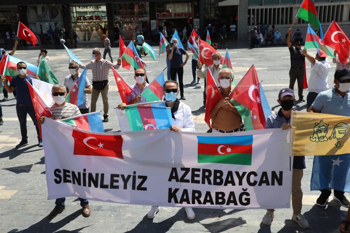 Activists hold flags of Turkey and Azerbaijan as they gather in Ankara, on August 8, 2020 [ADEM ALTAN/AFP via Getty Images]
