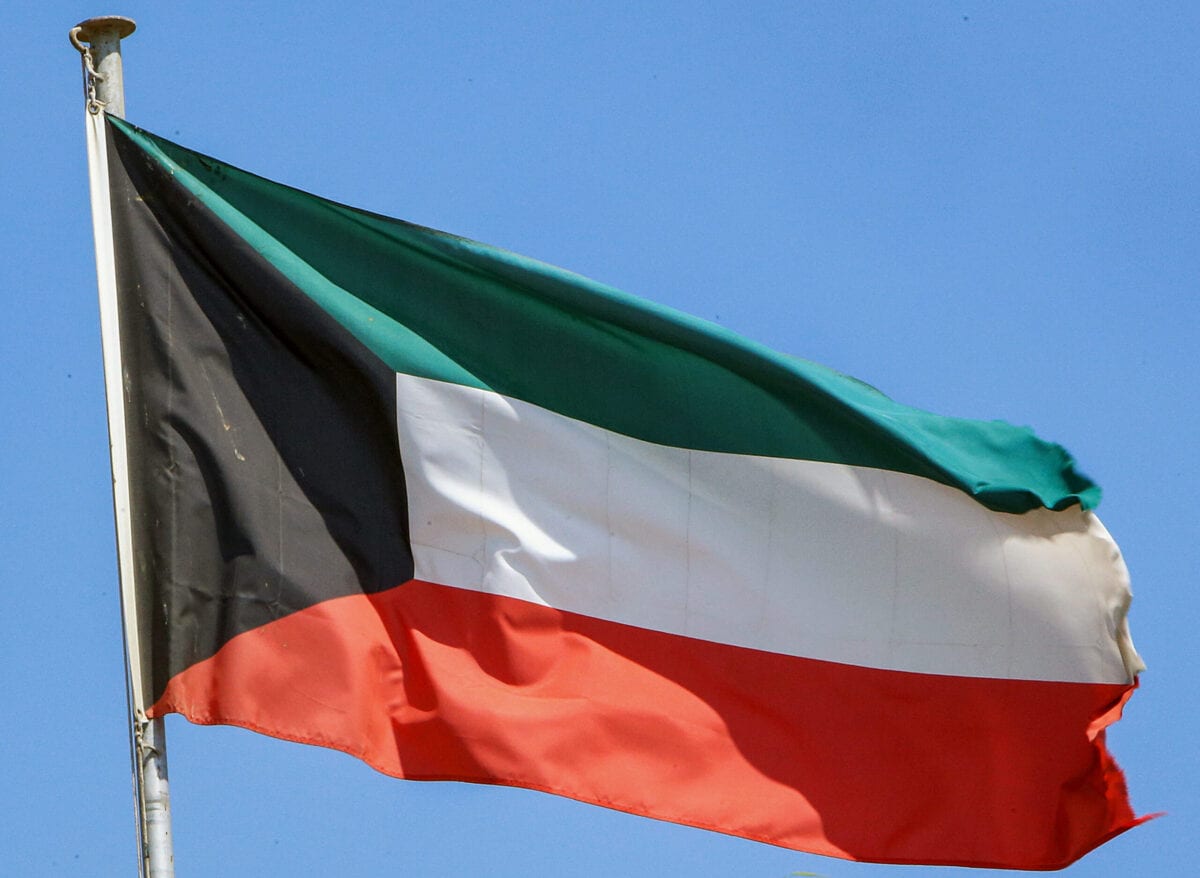 This picture taken on September 20, 2020 shows a Kuwaiti national flag flying from a mast in Kuwait City [YASSER AL-ZAYYAT/AFP via Getty Images]