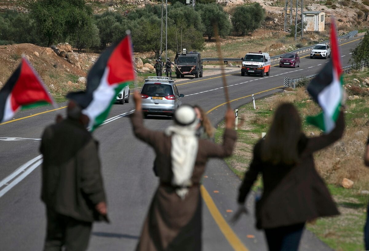Palestinians block a road to stop Israeli settlers from passing during a demonstration against Jewish settlements in the village Kafr Malik in the Israeli-occupied West Bank, on November 20, 2020 [ABBAS MOMANI/AFP via Getty Images]