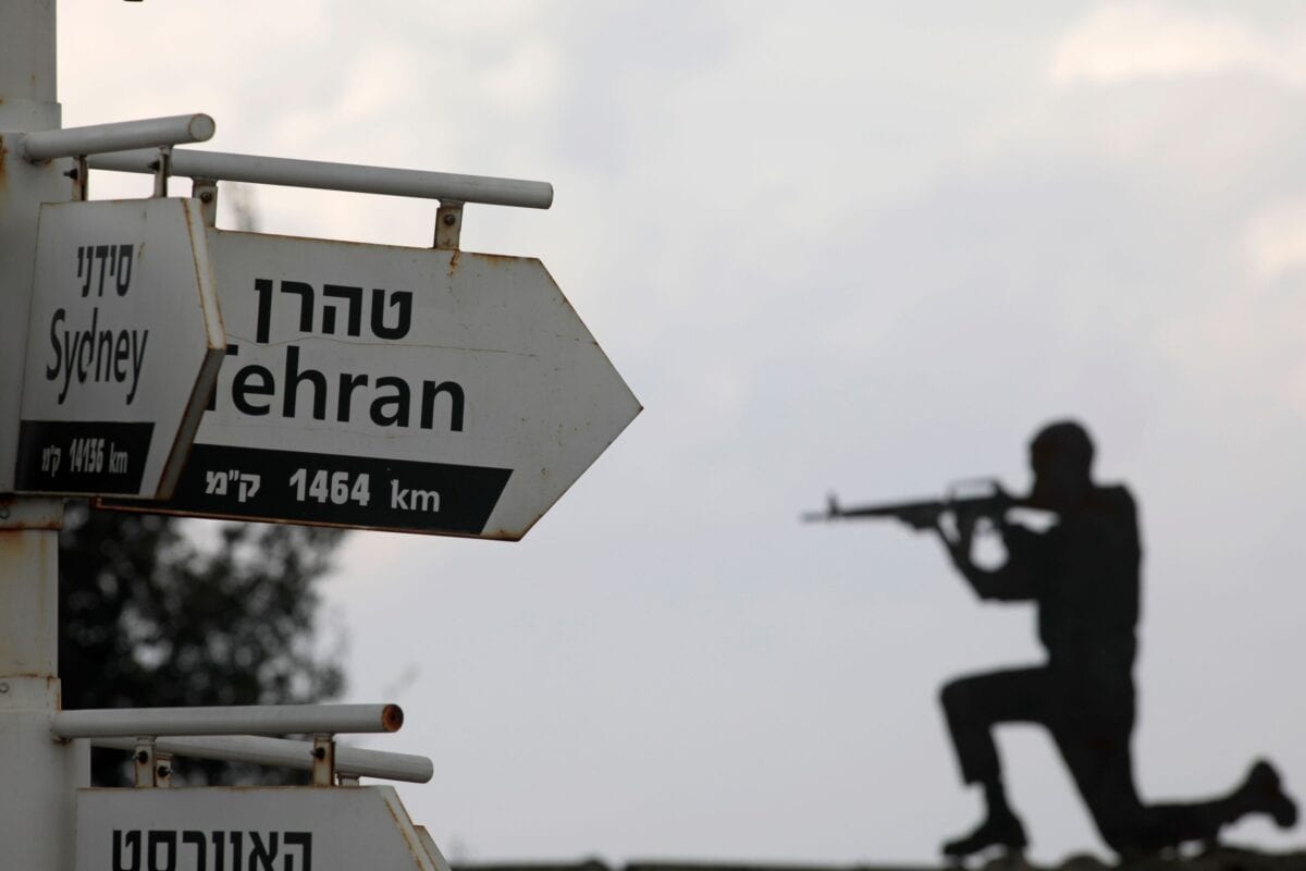A cutout of an Israeli soldier is seen behind signs pointing out distances to different cities at an army post in Mount Bental in the Israeli-annexed Golan Heights, on November 28, 2020 [JALAA MAREY/AFP via Getty Images]