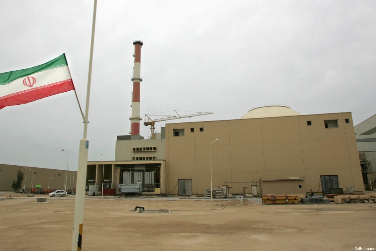 File picture dated April 3, 2007 shows an Iranian flag outside the building housing the reactor of the Bushehr nuclear power plant in the southern Iranian port town of Bushehr [BEHROUZ MEHRI/AFP FILES/AFP via Getty Images]