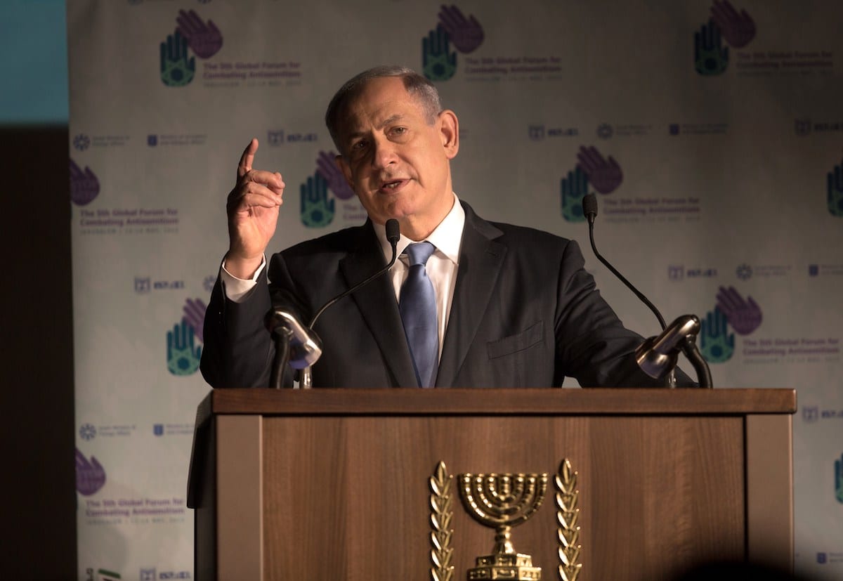 Israeli Prime Minister Benjamin Netanyahu delivers a speech at the 5th Global Forum for Combating Anti-Semitism conference at the International Convention Center in Jerusalem, on 12 May 2015. [MENAHEM KAHANA/AFP via Getty Images]
