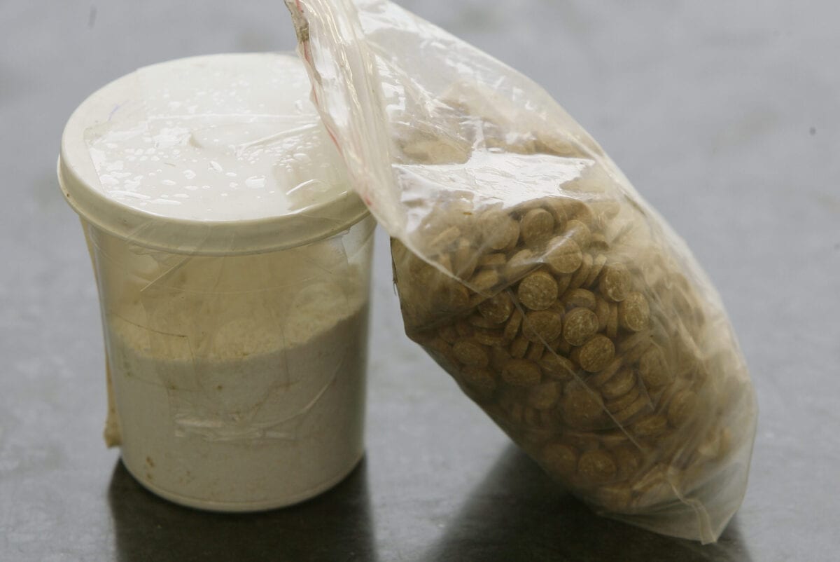 Captagon pills are displayed along with a cup of cocaine at an office of the Lebanese Internal Security Forces in Beirut on June 11, 2010 [JOSEPH EID/AFP via Getty Images]