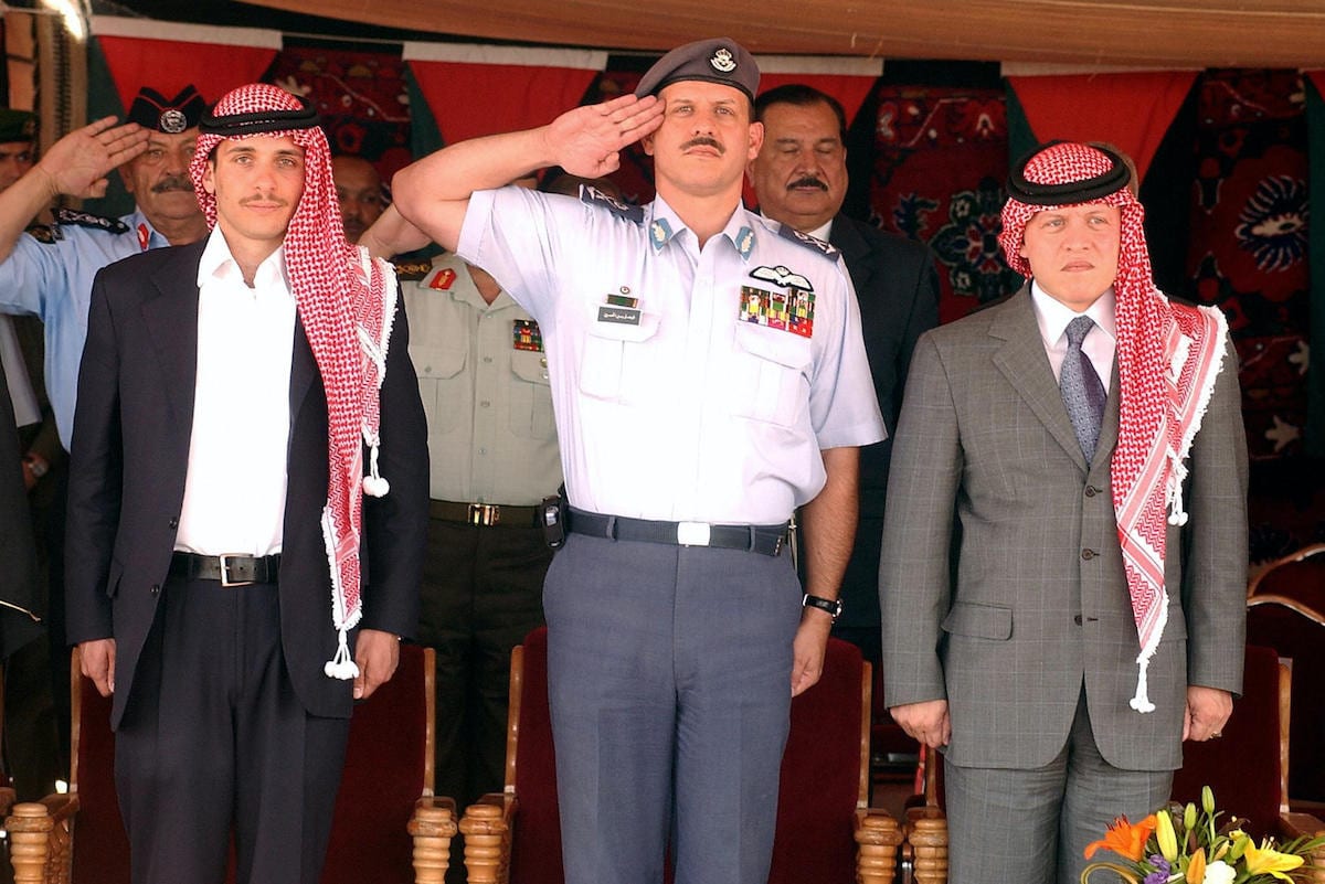 King Abdullah II of Jordan (R) and his brothers Crown Prince Hamzah (L) and Prince Faisal attend a lunch gathering held by representatives of Jordanian bedouin tribes in Amman's Royal Palace 26 May 2004. [MOHAMMED KESWANY/AFP via Getty Images]