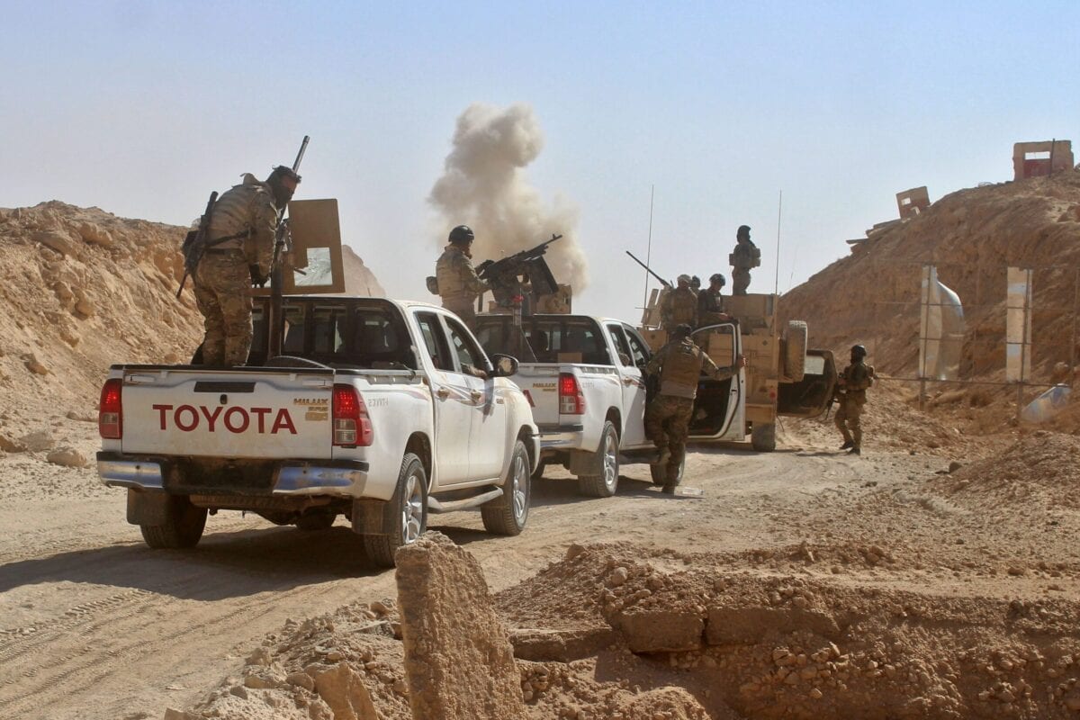 Iraqi security forces stop on a road behind smoke following a car bomb explosion on November 1, 2017 [MOADH AL-DULAIMI/AFP via Getty Images]