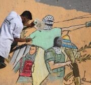 Palestinian artists draw murals on the ruins of Al-Shurouk Tower in Gaza to highlight the people’s steadfastness on 25 May 2021 [Mohammed Asad/Middle East Monitor]