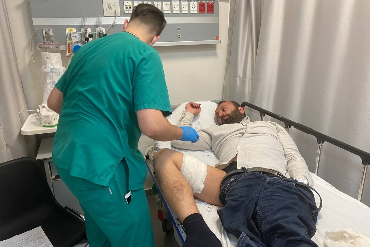 JERUSALEM - MAY 11: Anadolu Agency's Middle East News Editor Turgut Alp Poyraz receives medical treatment at Makassed Hospital after he was injured from his leg with 2 rubber bullets in an attack by the Israeli police on Muslim worshippers in the Al-Aqsa Mosque on May 11, 2021 in Jerusalem. ( Mustafa Deveci - Anadolu Agency )