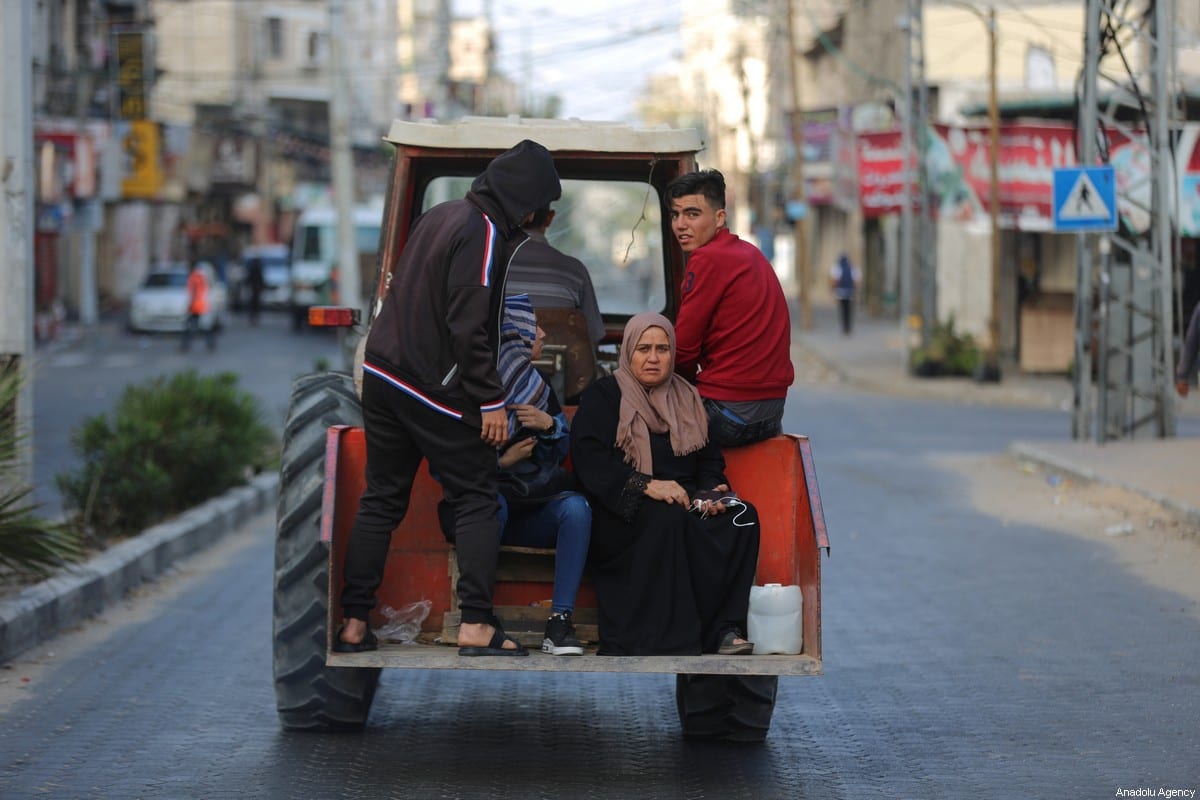 Palestinian families, fleeing from their homes with their belongings, are on their way to take shelter in a school owned by the United Nations Relief and Works Agency for Palestine Refugees in the Near East (UNRWA) as Israeli forces continue to pound Gaza Strip on May 14, 2021, in Gaza City, Gaza [Ali Jadallah/Anadolu Agency]