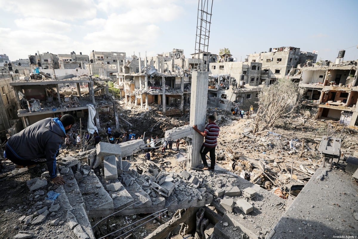 Palestinians search for survivors in the rubble of buildings destroyed by ongoing Israeli airstrikes on Gaza, in Beit Hanoun, Gaza on May 14, 2021 [Ali Jadallah / Anadolu Agency]