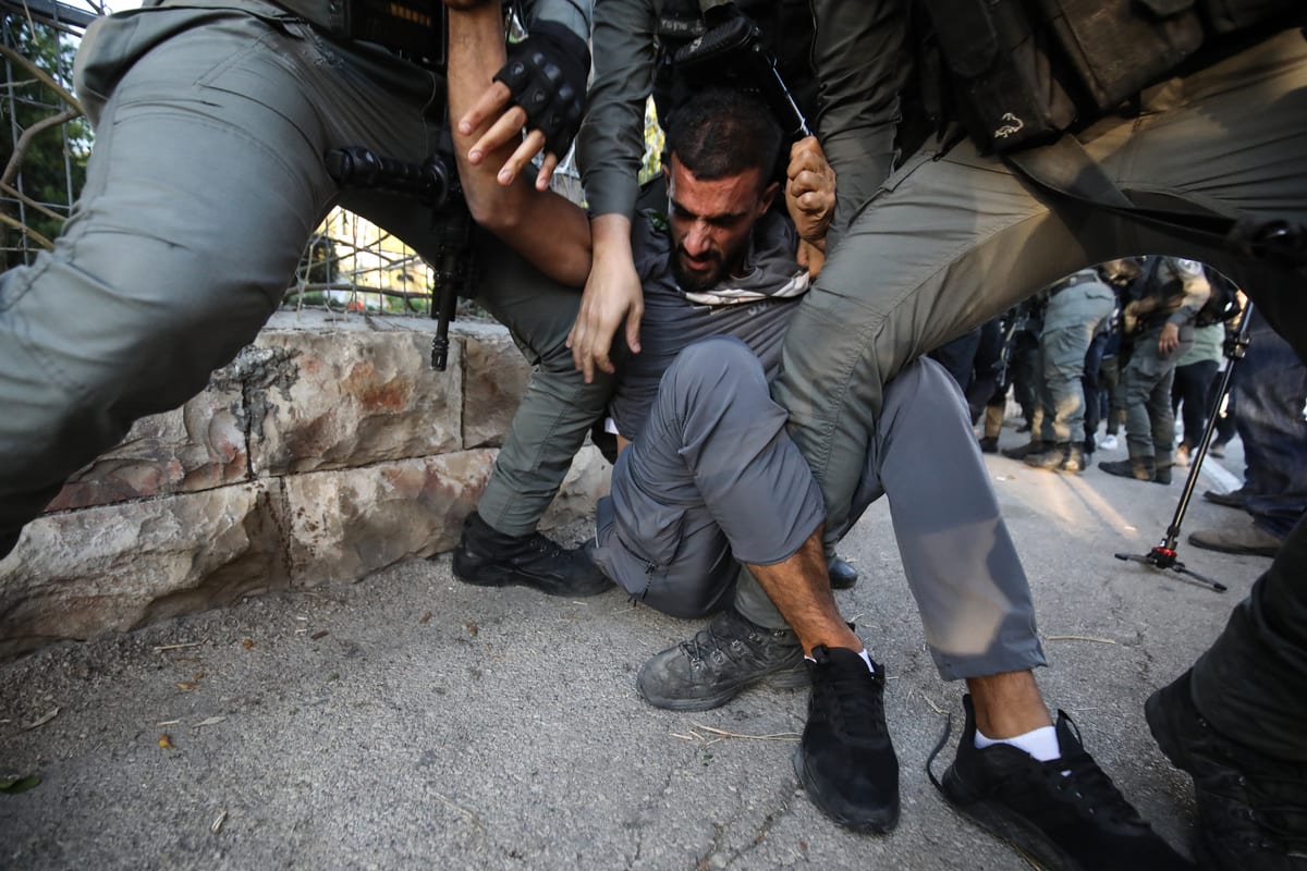 Israeli forces arrest a Palestinian man during a protest in Sheikh Jarrah neighbourhood of East Jerusalem on 15 May 2021 [Mostafa Alkharouf/Anadolu Agency]