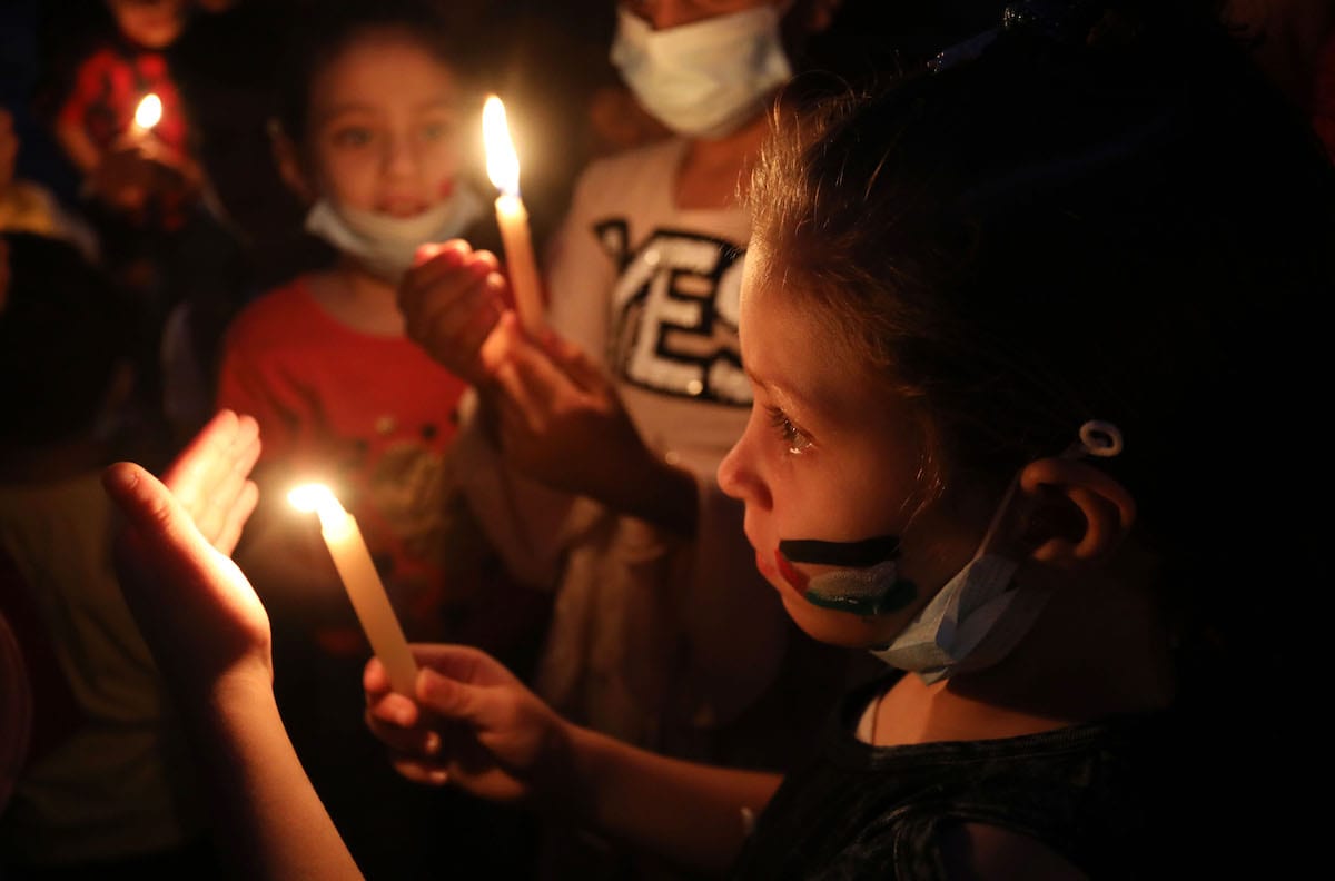 Palestinian kids light candles in memory of Abu Hattab family killed in the Israel attacks on Gaza, on May 23, 2021 in Gaza City, Gaza.
[Ashraf Amra - Anadolu Agency]
