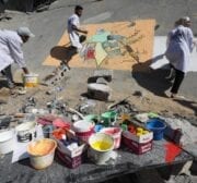 Palestinian artists draw murals on the ruins of Al-Shurouk Tower in Gaza to highlight the people’s steadfastness on 25 May 2021 [Mohammed Asad/Middle East Monitor]