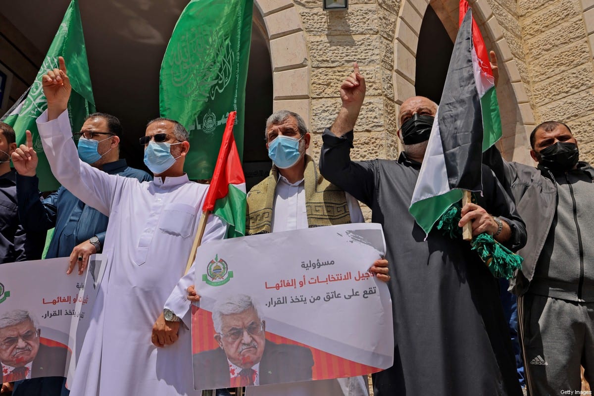 Supporters of the Hamas movement take part in a rally against the decision of the Palestinian authorities president to delay the legislative and presidential polls scheduled for May 22 and July 31, respectively, in Gaza City on April 30, 2021 [MAHMUD HAMS/AFP via Getty Images]
