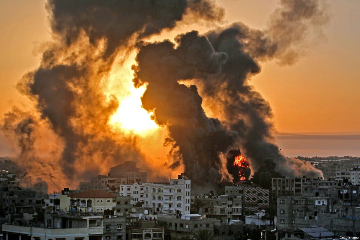 A fire rages at sunrise in Khan Yunish following an Israeli airstrike on targets in the southern Gaza strip, early on May 12, 2021 [YOUSSEF MASSOUD/AFP via Getty Images]