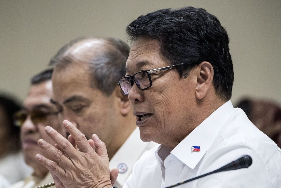 Philippine Labour Secretary Silvestre Bello gestures during a hearing on migrant workers at the Senate building in Manila on 21 February 2018. [NOEL CELIS/AFP via Getty Images]