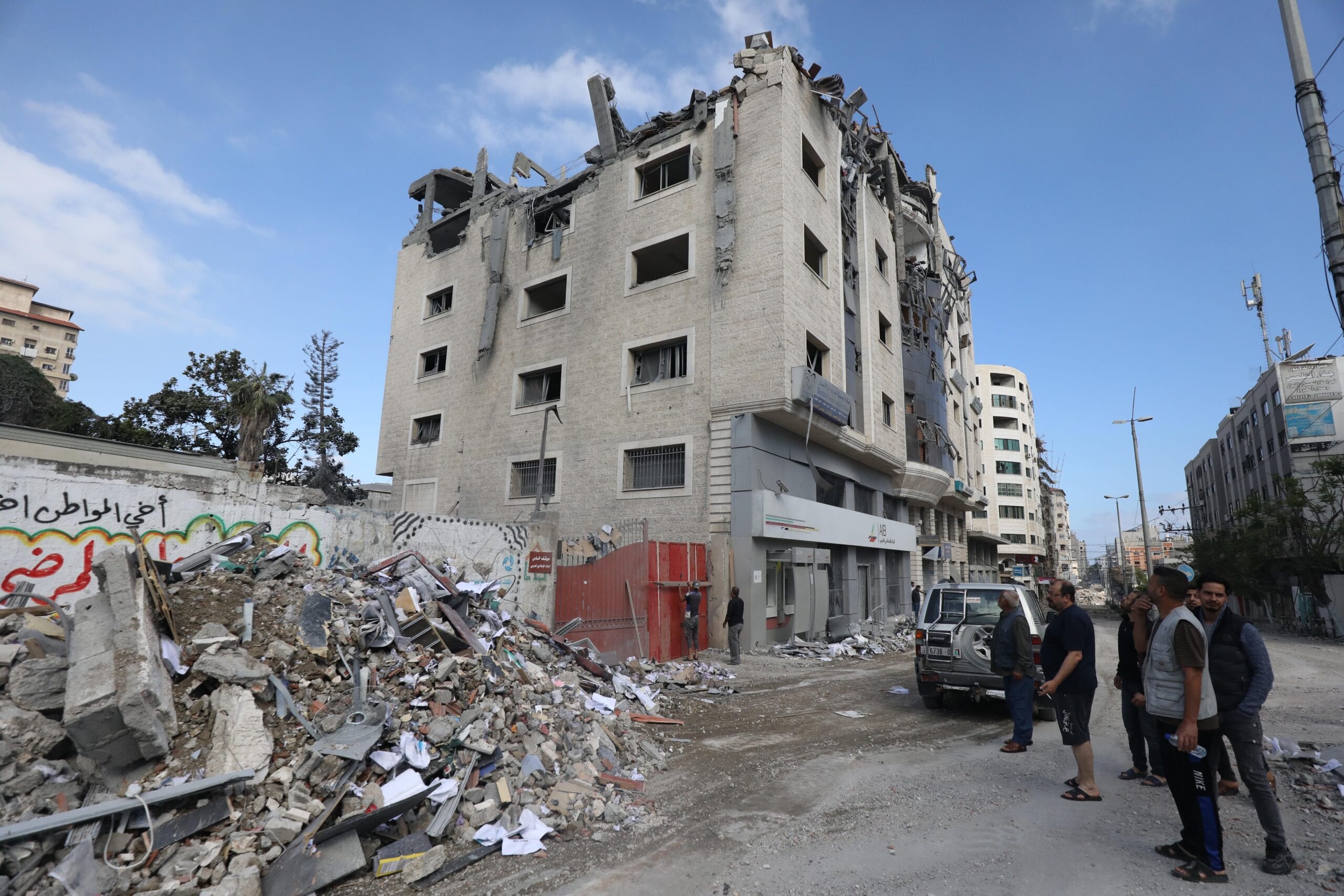 Israeli air strikes level a 6-storey residential building which was also home to the Nafha Centre for Israeli Studies in Gaza City [Mohammed Asad/Middle East Monitor]