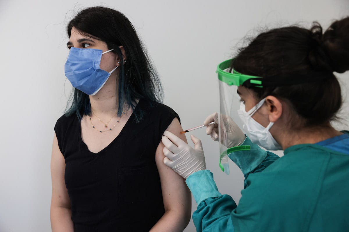A teacher receives Covid-19 vaccine at Feriha Oz intensive care unit as vaccination for teachers and school staff starts on June 7, 2021 in Istanbul, Turkey [Elif Öztürk Özgöncü/Anadolu Agency]
