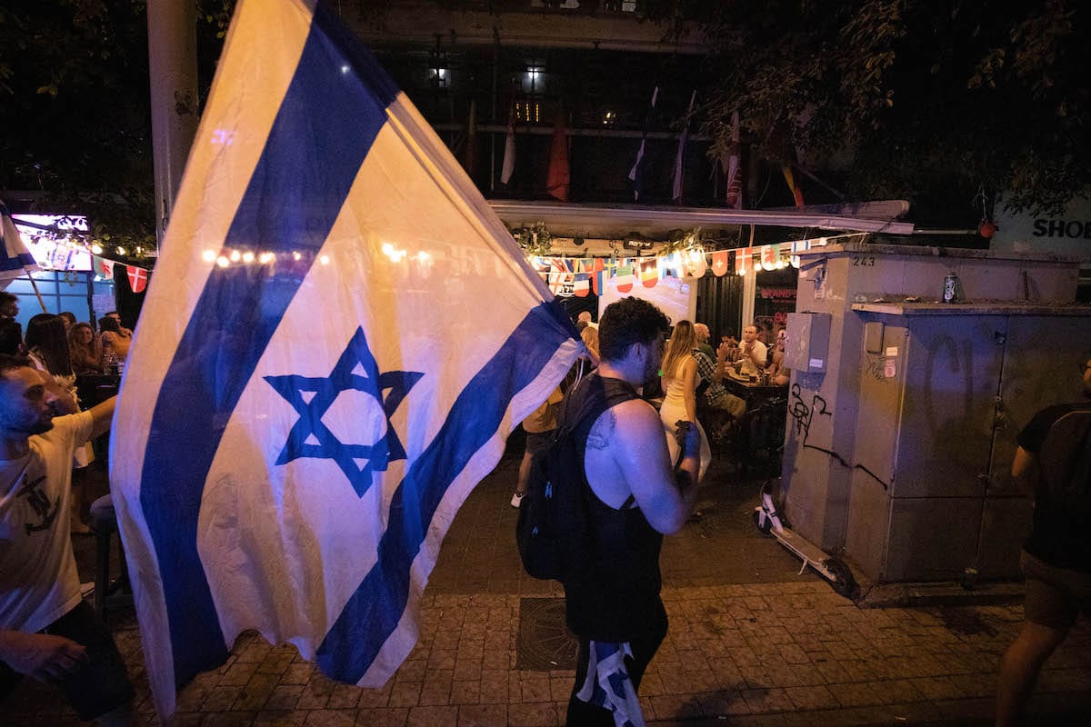 Thousands of Israelis celebrate the country's new government, ending the 12-year reign of Premier Benjamin Netanyahu at Rabin Square in Tel Aviv, Israel on June 13, 2021 [Eyad Tawil‎ / Anadolu Agency]