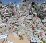 Photos of children, who lost their lives in Israel's attacks on Gaza, are exhibited at debris of Es-Sekka family's house in Khan Yunis, Gaza on June 19, 2021 [Ashraf Amra / Anadolu Agency]