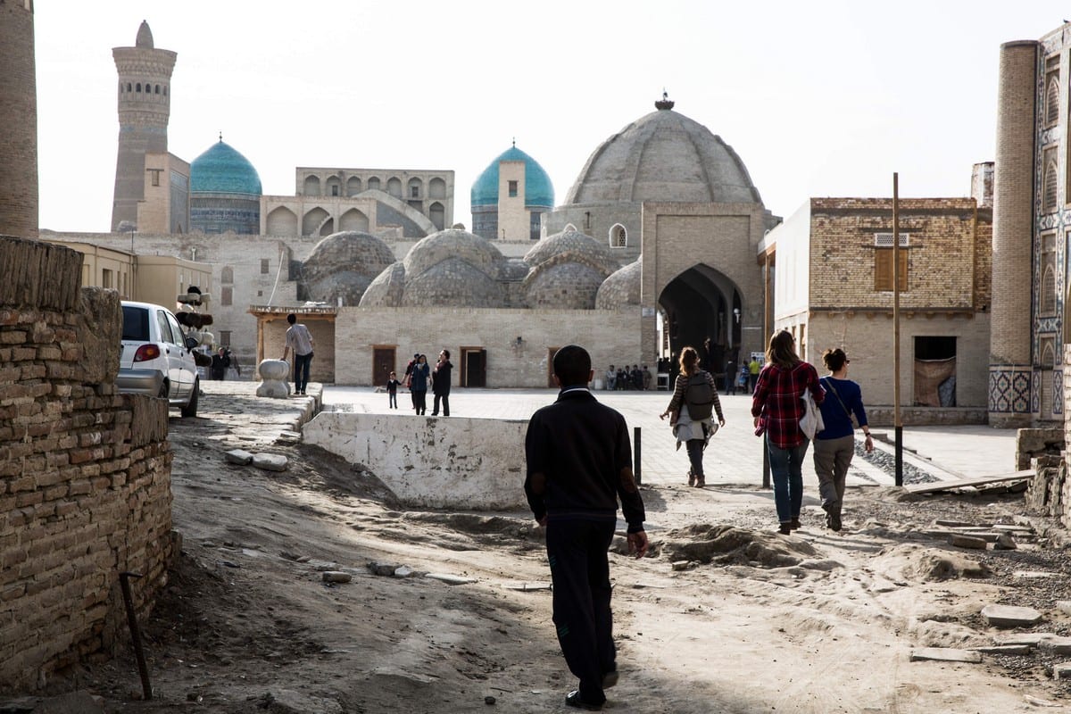 Pedestrians walk towards the old city in Bukhara, Uzbekistan, 8 March 2018 [Taylor Weidman/Bloomberg/Getty Images]