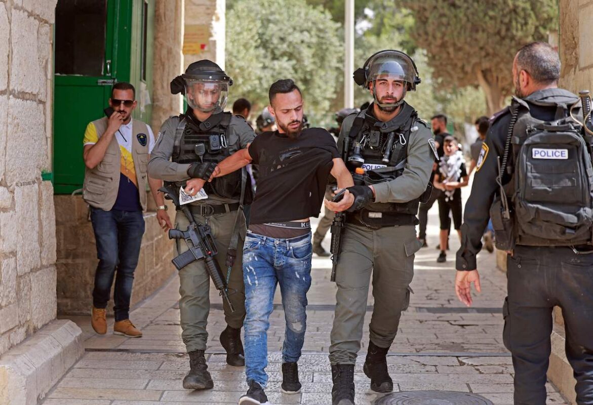 Israeli security forces detain a Palestinian man at the entrance of Jerusalem's al-Aqsa mosque compound, on 21 May 2021 [MENAHEM KAHANA/AFP via Getty Images]