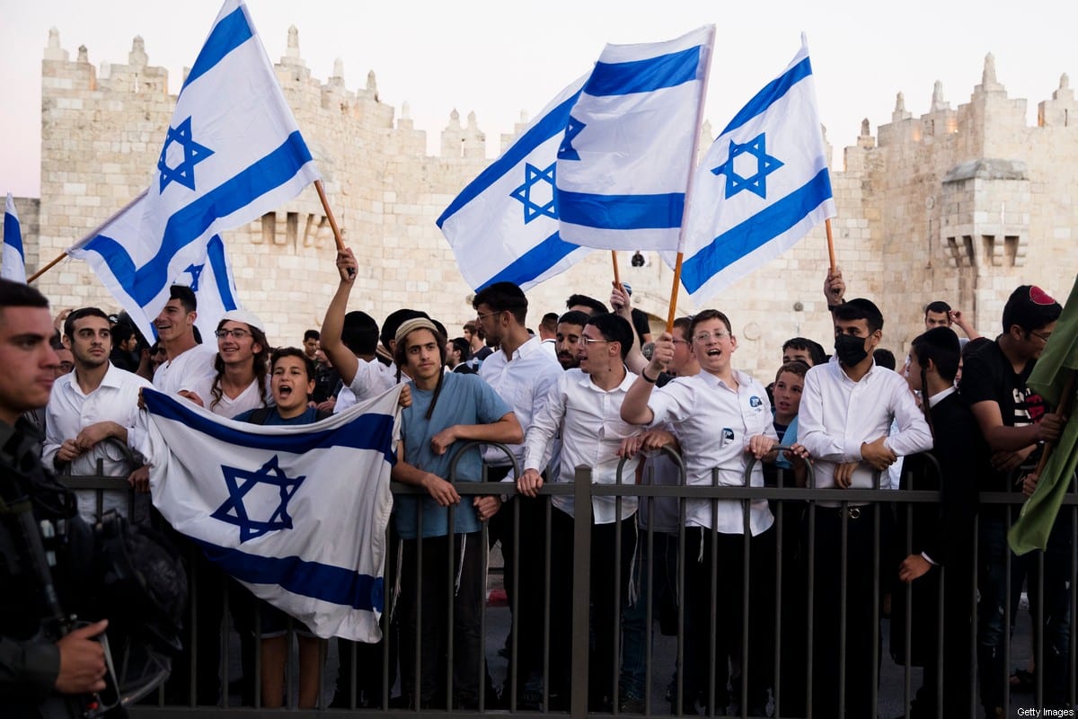 Israelis hold flags as they march near Damascus Gate during the flag march on June 15, 2021 in Jerusalem, Israel [Amir Levy/Getty Images]