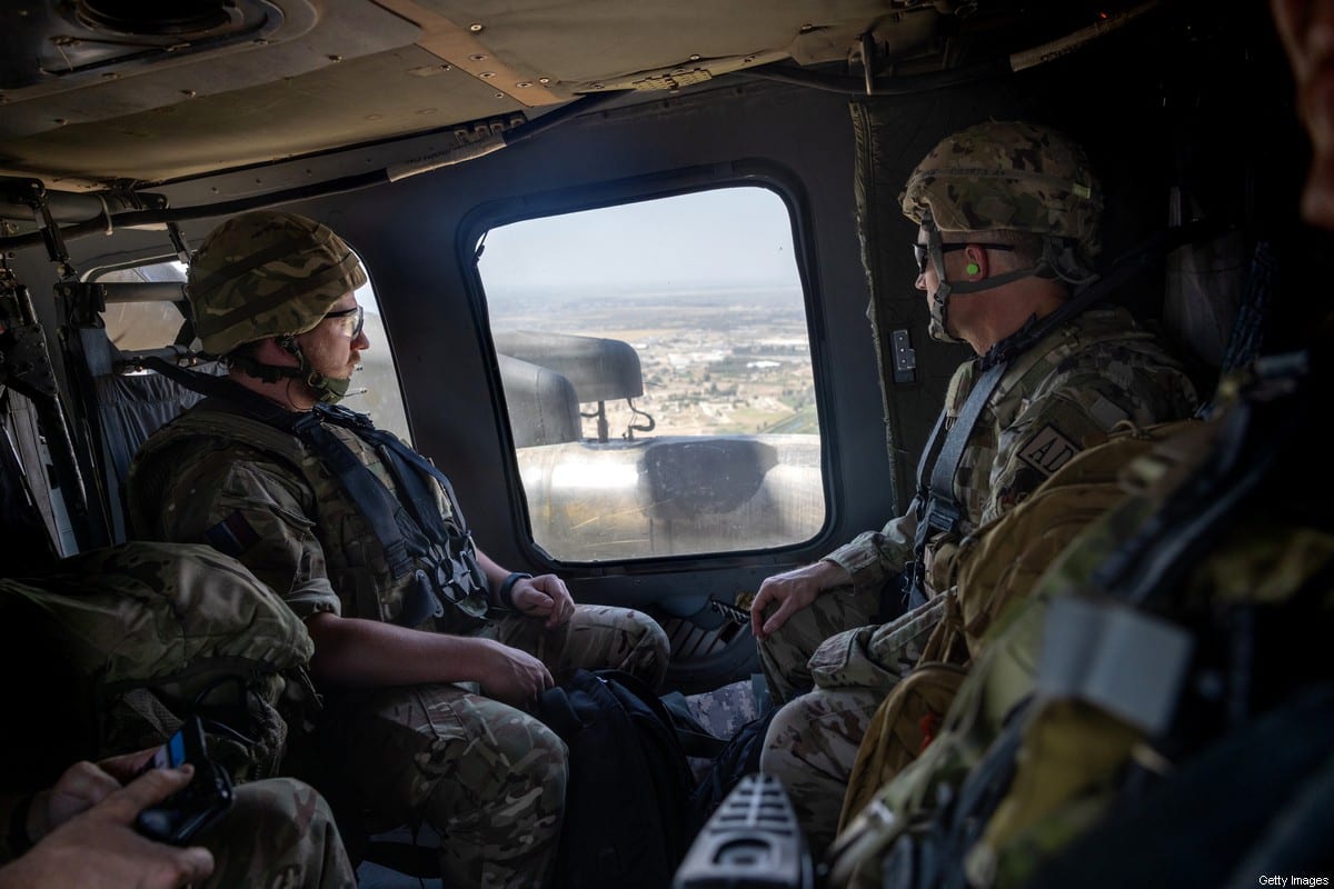 Coalition soldiers fly to Baghdad International Airport from the International Zone in a U.S. Blackhawk helicopter on May 31, 2021 in Baghdad, Iraq. [Photo by John Moore/Getty Images]