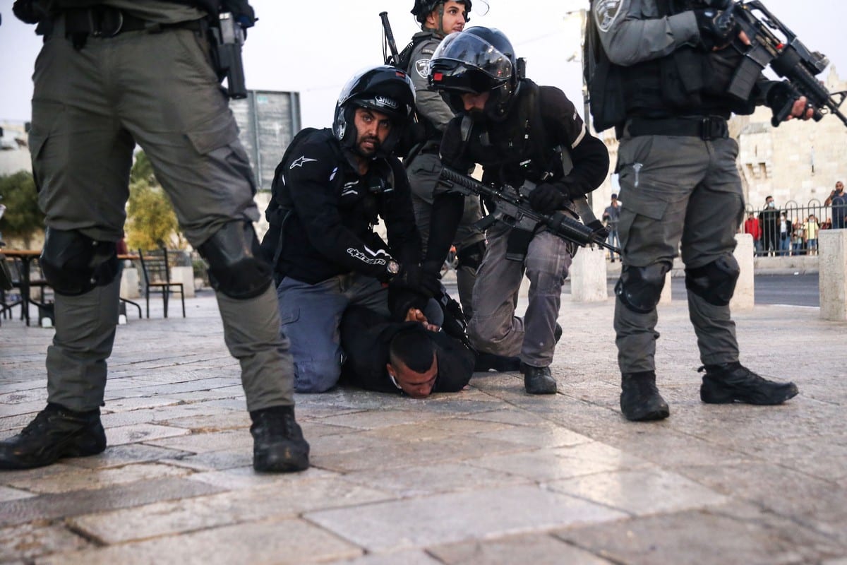 A Palestinian youth is detained by Israeli forces as a group of Palestinian gather to protest against far-right Israelis' slogans insulting Prophet Muhammad during yesterday's "flag march" at Damascus Gate in Old City of Jerusalem on June 17, 2021 [Mostafa Alkharouf / Anadolu Agency]