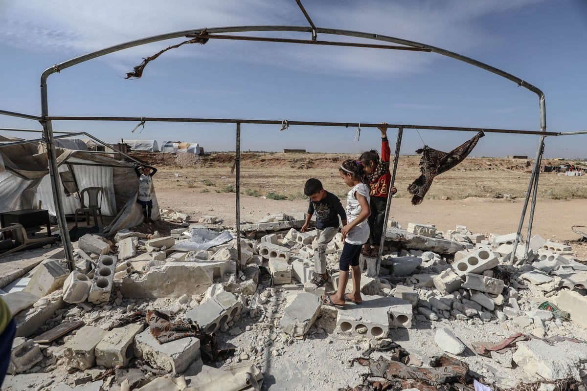 Syrian children are seen among the rubble of a collapsed school after it was hit by Assad Regime in Idlib, Syria on 11 June 2021 [Izzeddin Kasim/Anadolu Agency]