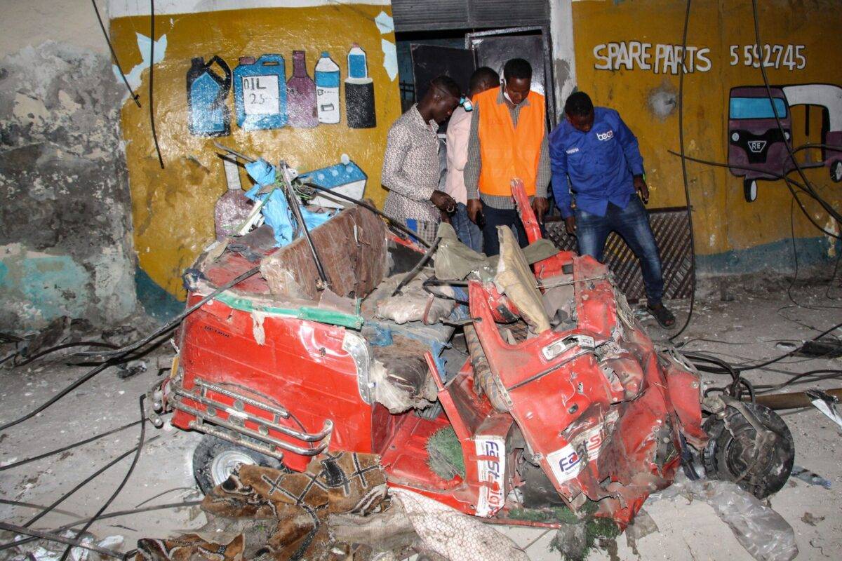 A picture taken on March 5, 2021, shows people removing power cables after a car bombing exploded in Mogadishu, Somalia [AFP via Getty Images]