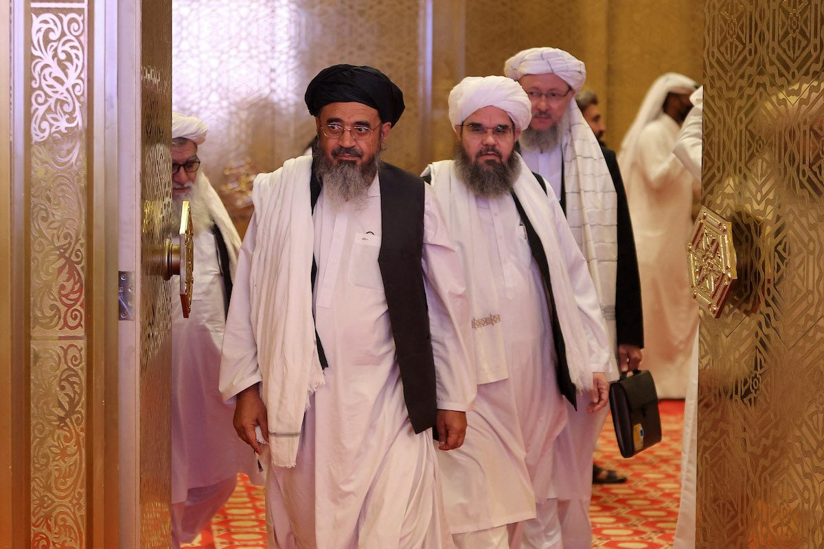 Members of the Taliban delegation arrive for the presentation of the final declaration of the peace talks between the Afghan government and the Taliban in Qatar's capital Doha on July 18, 2021. [KARIM JAAFAR/AFP via Getty Images]