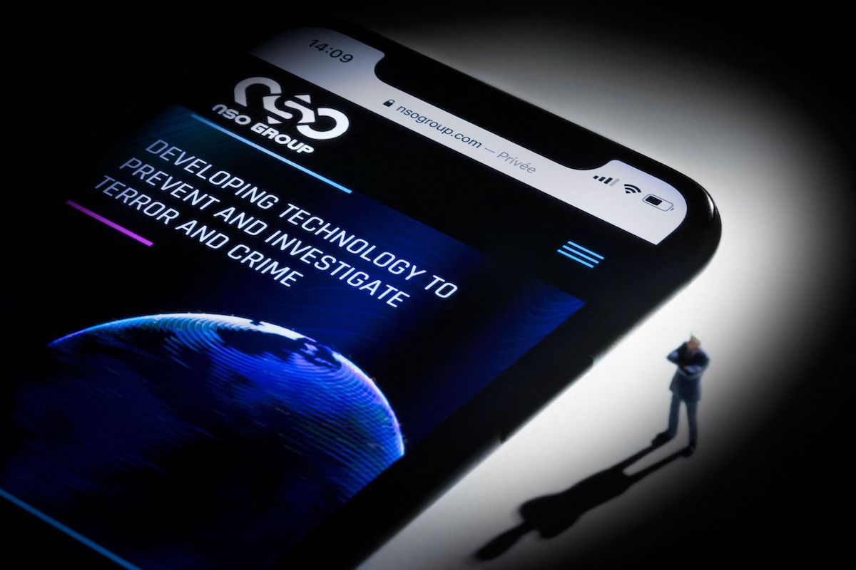This studio photographic illustration shows a smartphone with the website of Israel's NSO Group which features 'Pegasus' spyware, on display in Paris on July 21, 2021. [JOEL SAGET/AFP via Getty Images]