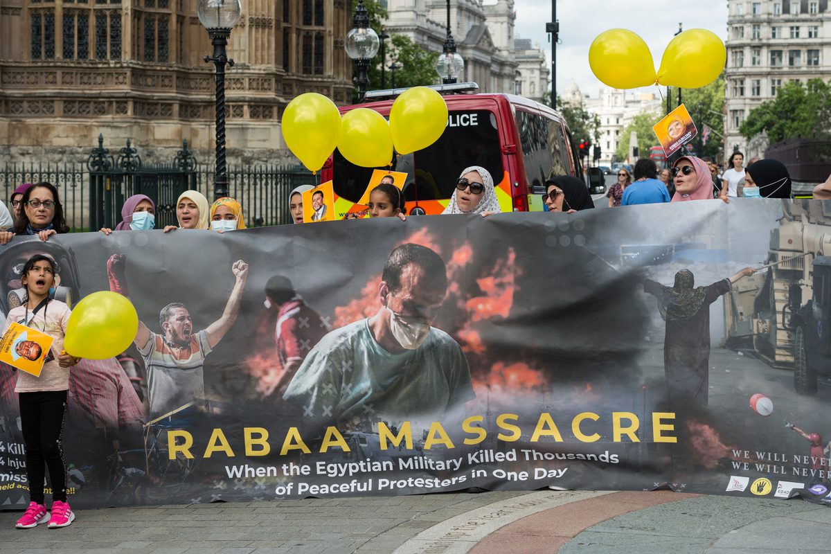 Members of the British Egyptian community stage a demonstration outside Houses of Parliament on the eight anniversary of the massacre of civilians during a peaceful protest in Cairo's Rabaa Square in London, United Kingdom on August 14, 2021. [Wiktor Szymanowicz - Anadolu Agency]