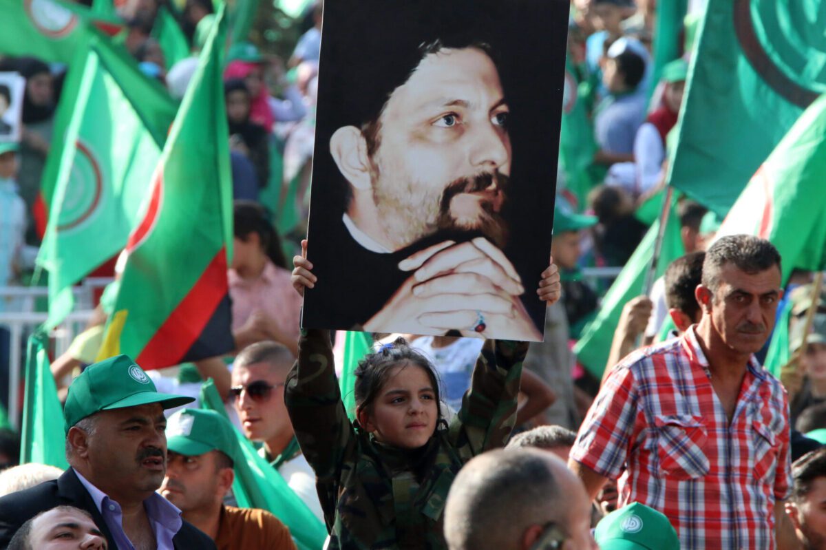 Amal movement supporters hold up pictures of Imam Musa al-Sadr in Beirut on August 31, 2018 [STR/AFP via Getty Images]
