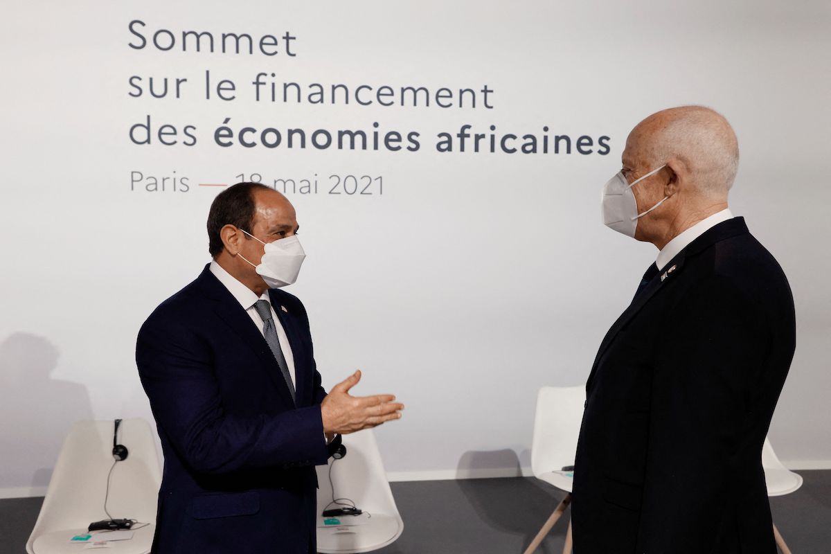 Egyptian President Abdel Fattah al-Sisi (L) speaks with Tunisia's President Kais Saied (R) before the opening session of the Summit on the Financing of African Economies on 18 May 2021 in Paris. [LUDOVIC MARIN/POOL/AFP via Getty Images]