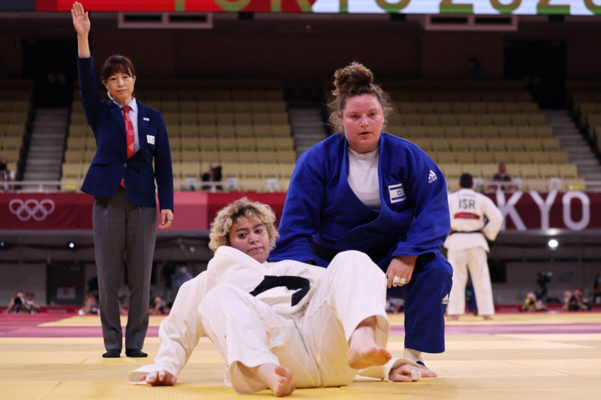 Israel's Raz Hershko (blue) and Saudi Arabia's Tahani Alqahtani compete in the judo women's +78kg elimination round bout during the Tokyo 2020 Olympic Games at the Nippon Budokan in Tokyo on July 30, 2021 [JACK GUEZ/AFP via Getty Images]