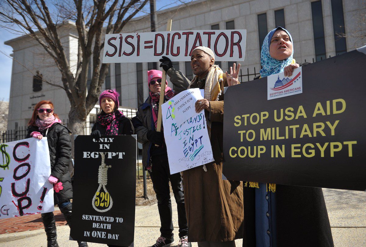 Demonstrators take part in a protest against the government of Egypt on March 27, 2014 outside of the Embassy of Egypt in Washington, DC. [MANDEL NGAN/AFP via Getty Images]