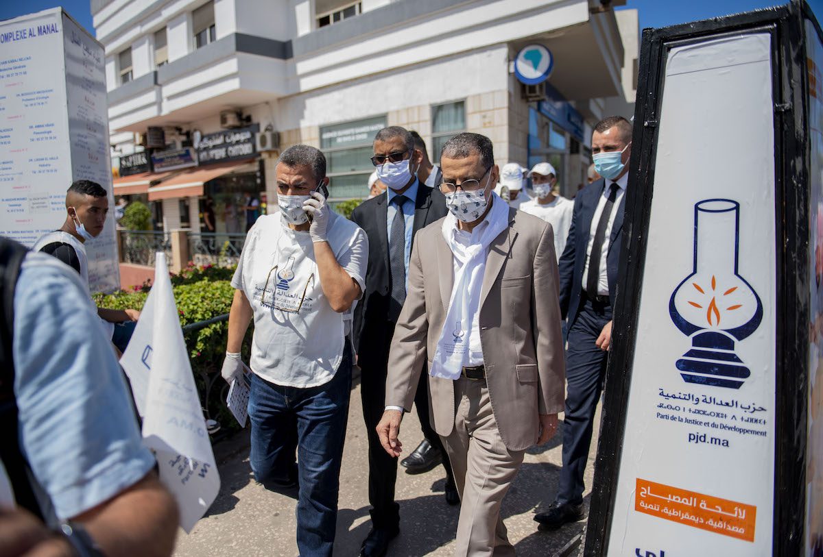 General secretary of Justice and Development Party Saad-Eddine El Othmani (R) visits shop owners at Al Manal Mall ahead of the general elections to be held in September 8, in Rabat, Morocco on 29 August 2021. [Jalal Morchidi - Anadolu Agency]