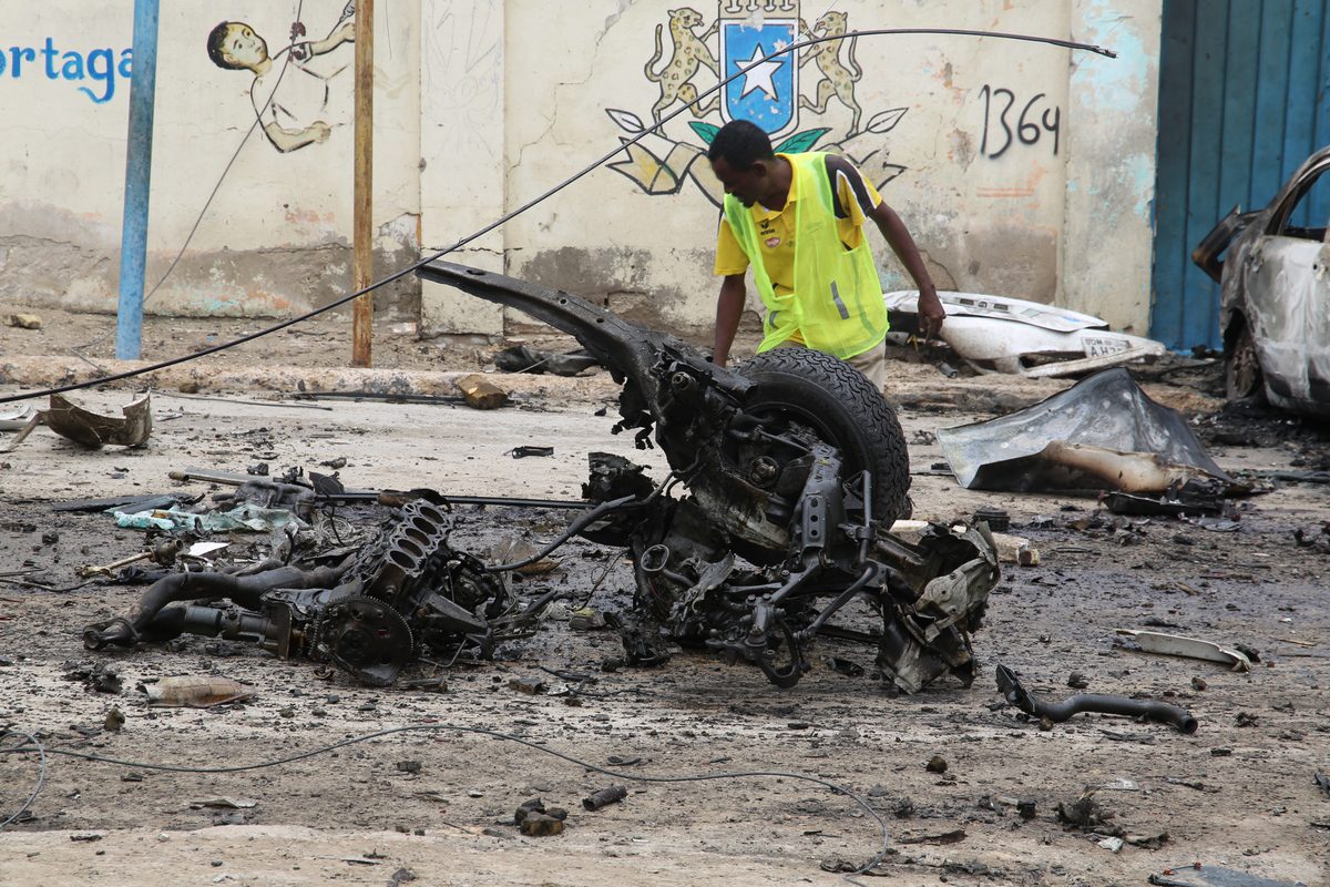 Crime scene officials inspect the suicide car bombing area in Mogadishu, Somalia on September 25, 2021 [Sadak Mohammed/Anadolu Agency]