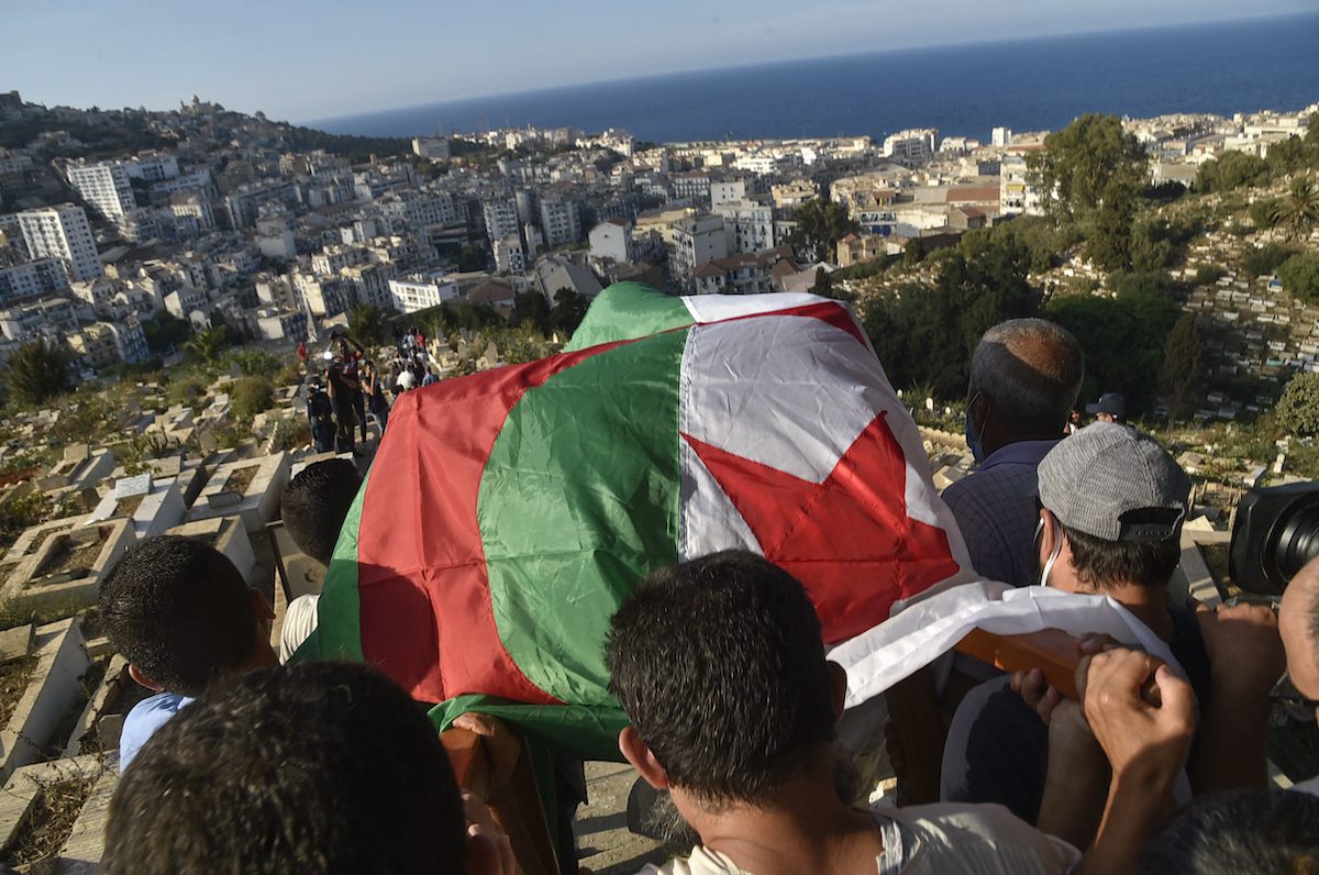 Algerians carry the coffin of former military leader of Algeria's FLN (National Liberation Front) networks of the autonomous zone of Algiers Yacef Saadi, during his funeral at the El Kettar cemetery in the capital Algiers, on 11 September 2021. [RYAD KRAMDI/AFP via Getty Images]