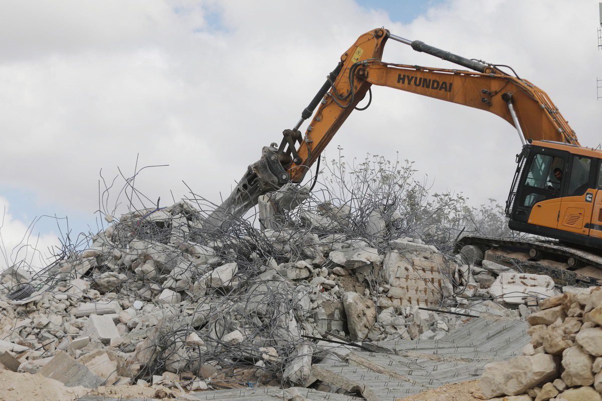 Israeli bulldozers demolish two Palestinian houses under construction in Hebron, West Bank on October 18, 2021 [Mamoun Wazwaz/Anadolu Agency]