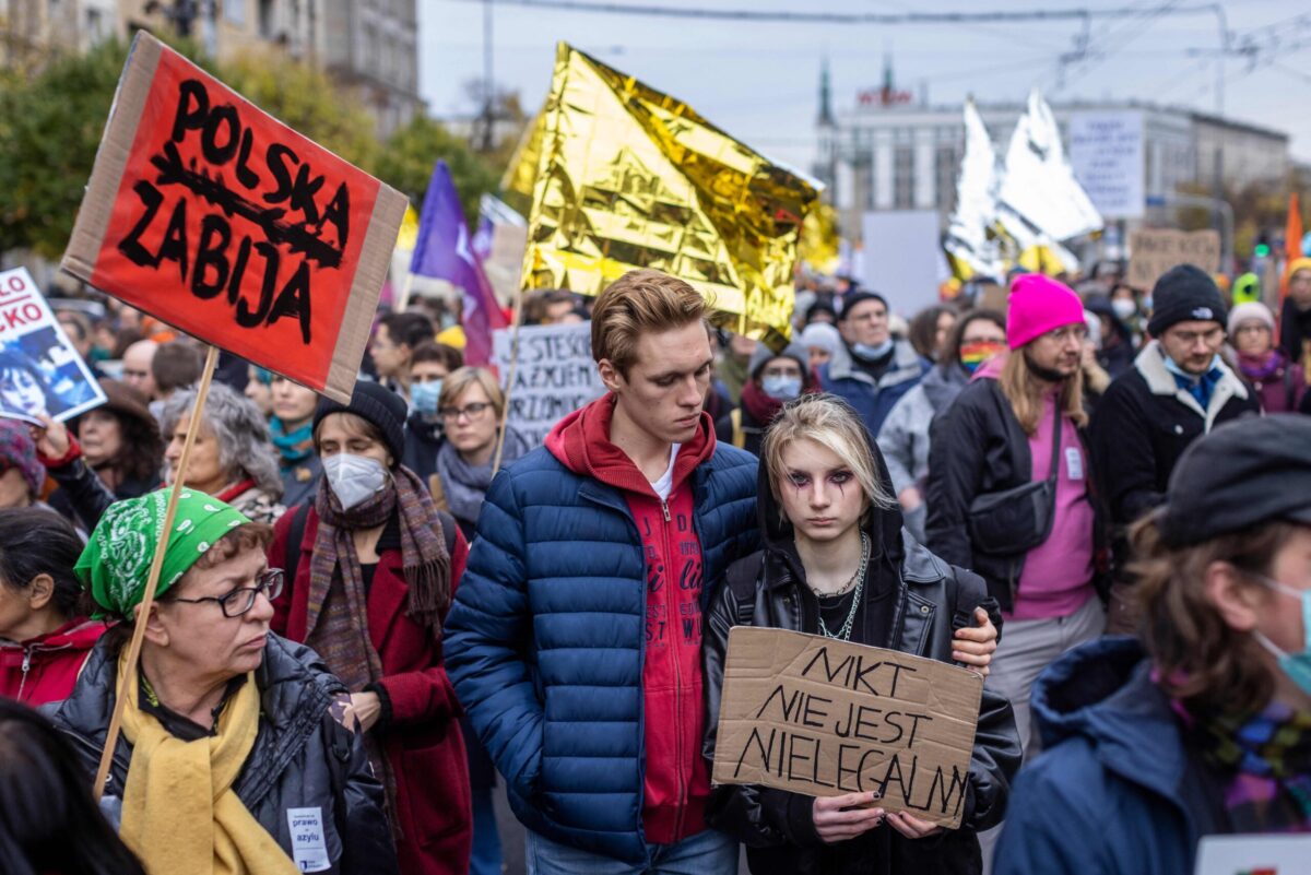 People take part in a protest rally in solidarity with migrants who have been pushed back at Poland's border with Belarus in Warsaw, October 17, 2021. Placard reads "No one is illegal" - Thousands of people demonstrated in Warsaw against pushbacks of migrants at the Polish-Belarusian border. Demonstrators marched through the Polish capital's centre bearing signs like "Stop torture at the border" and "Nobody is illegal". (Photo by Wojtek RADWANSKI / AFP) (Photo by WOJTEK RADWANSKI/AFP via Getty Images)