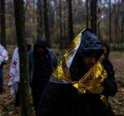 Syrian migrants walk through the forest near Hajnowka, Poland, during a joint rescue operation of activists from the "Grupa Granica" (Border Group) and volounteers from Medycy na Granicy (Medics on the Border), on October 23, 2021. - Thousands of migrants, mostly from the Middle East have crossed or tried to cross from Belarus since the summer. The EU believes the Belarusian regime is deliberately sending the migrants over in retaliation against EU sanctions. - TO GO WITH AFP STORY by Anna Maria JAKUBEK (Photo by Wojtek RADWANSKI / AFP) / TO GO WITH AFP STORY by Anna Maria JAKUBEK (Photo by WOJTEK RADWANSKI/AFP via Getty Images)