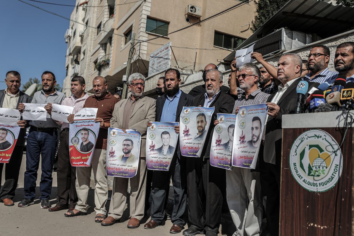 People hold banners during a demonstration in support of Palestinian prisoners on hunger strike in Israeli jails against Israel's administrative detention on November 03, 2021 [Ali Jadallah/Anadolu Agency]