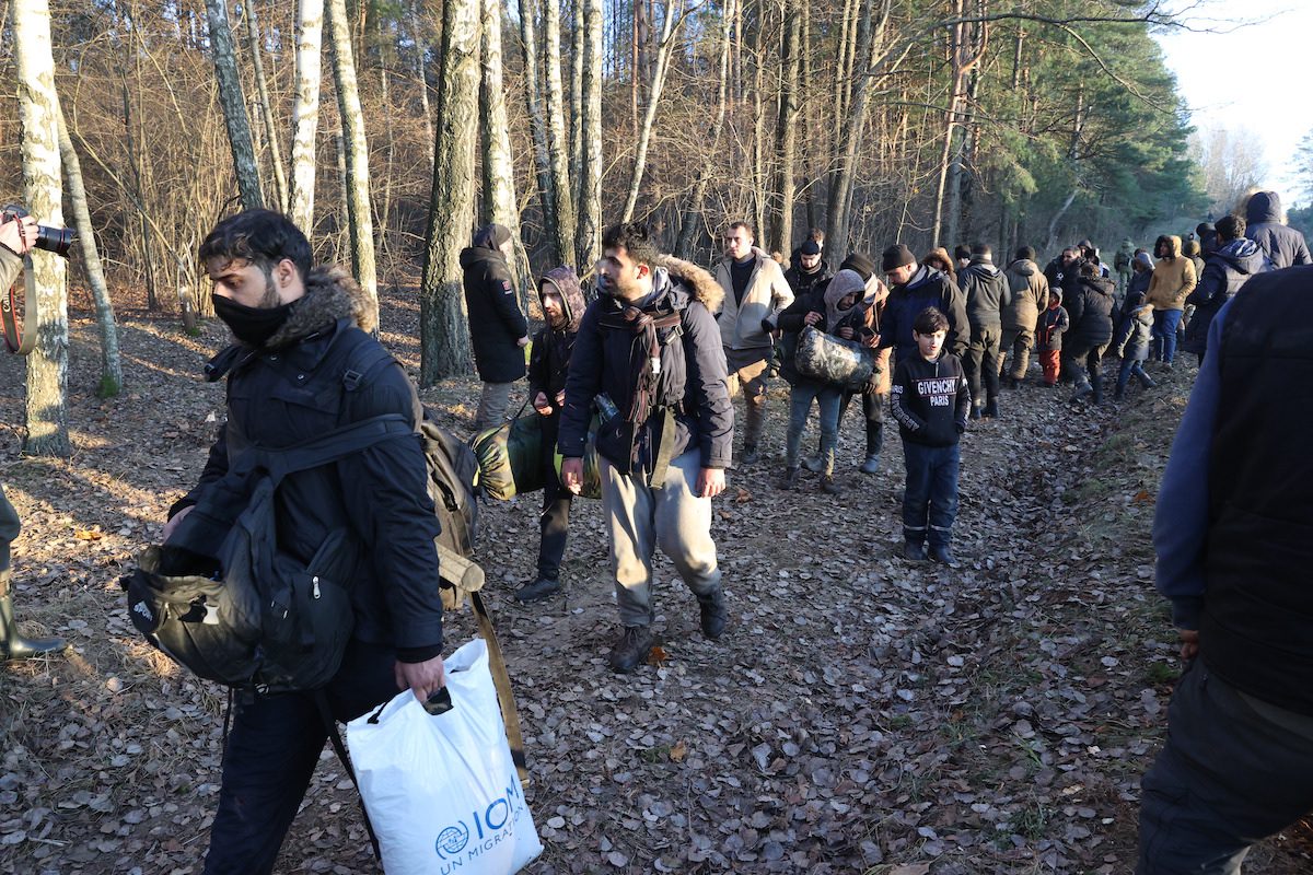 BELARUS - NOVEMBER 10: Irregular migrants continue to wait at the Polish-Belarusian border on November 10, 2021 in Belarus. Thousands of irregular migrants are facing desperate conditions as they continue waiting at the Polish-Belarusian border, hoping to cross onto EU soil. After crossing the Bruzgi border point in Grodno, Belarus on Monday, the immigrants – most of them from Iraq – came to the Polish border to spend Tuesday night. Nearly 2,000 immigrants, including many women and children, stayed in tents they set up in front of the border fences in the forested area. ( Stringer - Anadolu Agency )