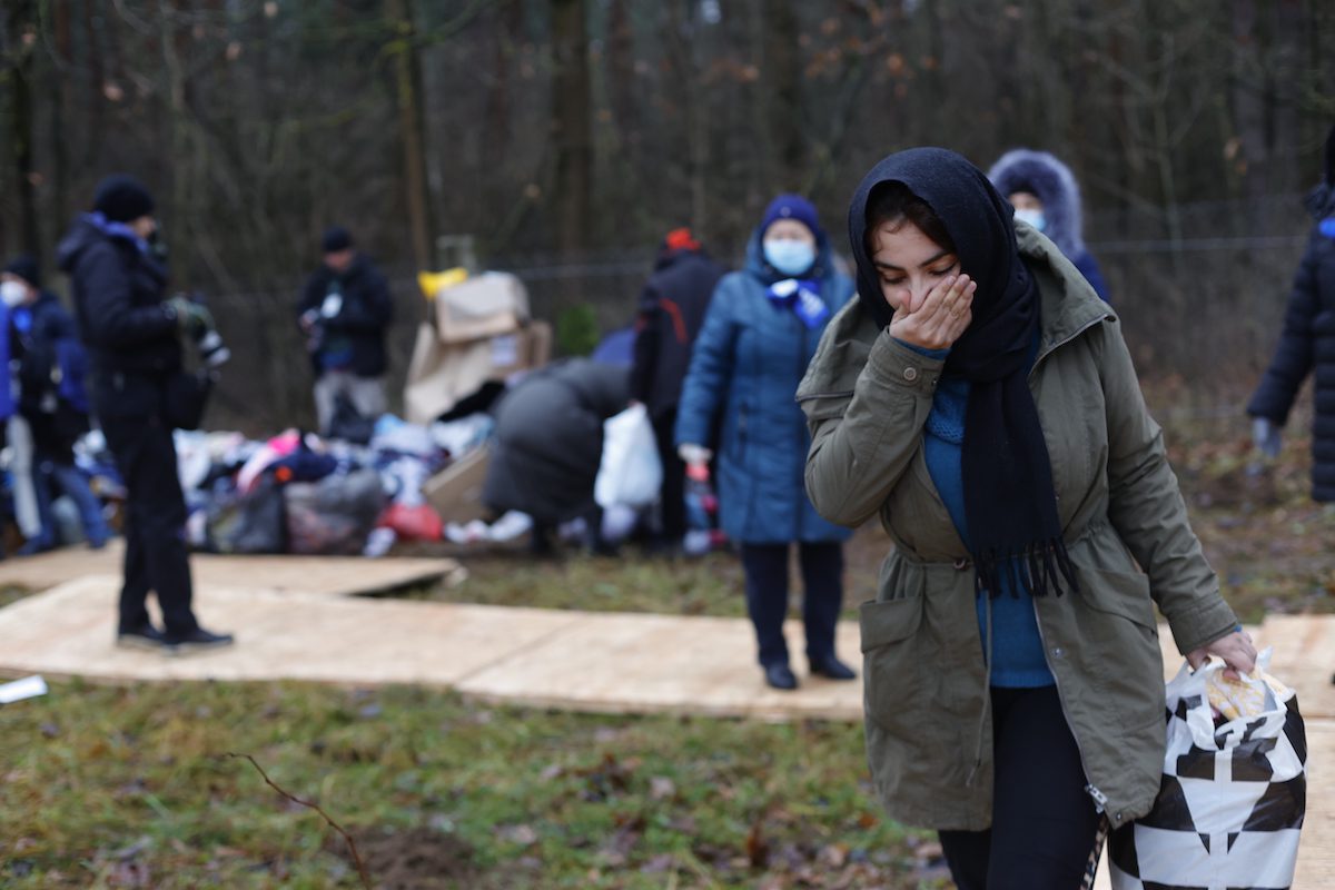 GRODNO REGION, BELARUS - NOVEMBER 24: Migrants receive humanitarian aid donated and collected by Grodno people as migrants continue to wait at a closed area allocated by Belarusian government the Belarusian-Polish border in Grodno, Belarus on November 24, 2021. The migrant crisis on the border of Belarus with Poland, Lithuania, and Latvia escalated on November 8. This year, Polish border guards have prevented more than 35,000 attempts to illegally cross the Polish-Belarusian border, which is 400 times more than last year. ( Sefa Karacan - Anadolu Agency )