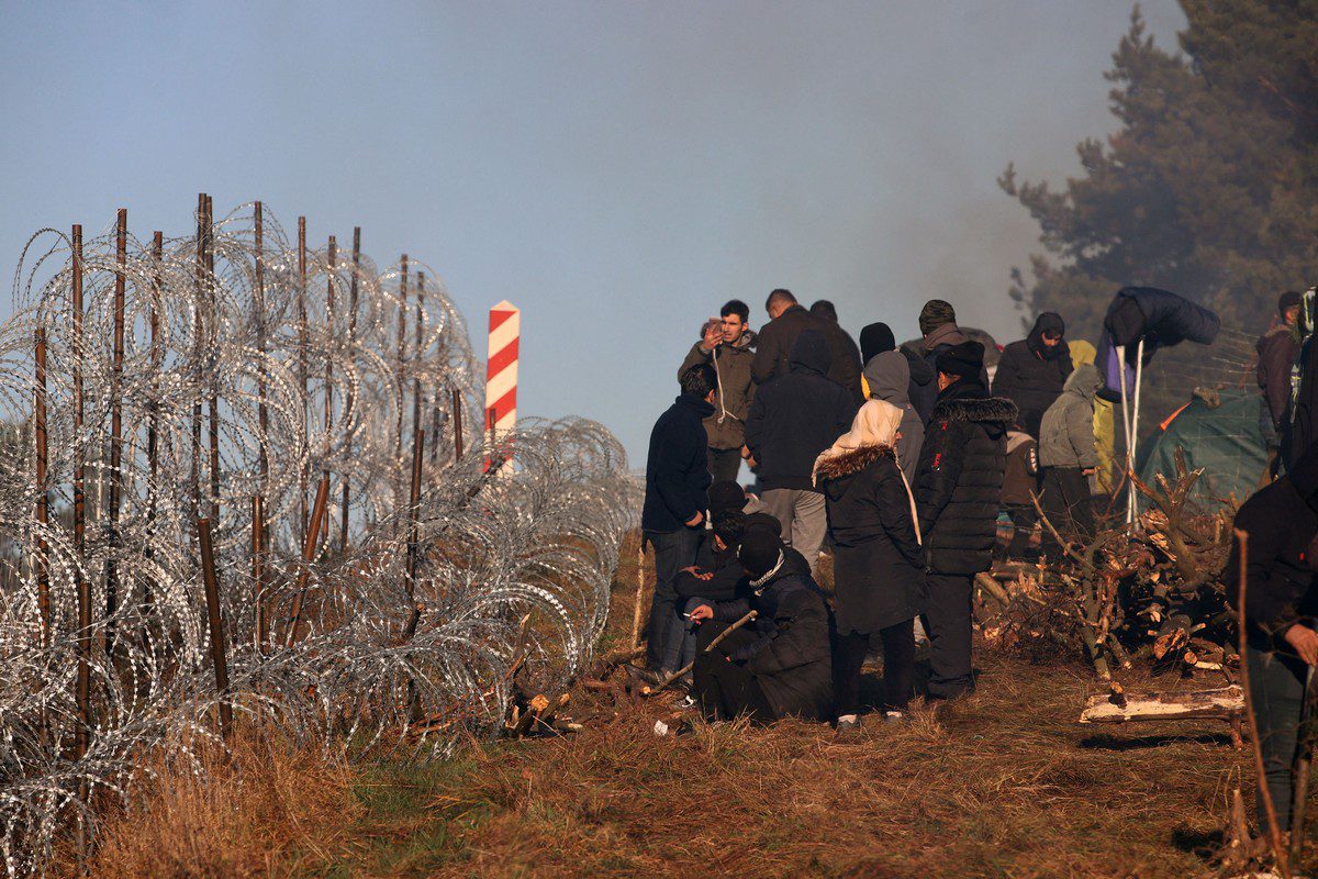 Migrants at the Belarusian-Polish border on 9 November 2021 [LEONID SHCHEGLOV/BELTA/AFP/Getty Images]