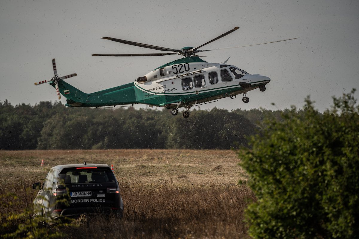 A Bulgarian Border Police car guards the land border between Bulgaria and Turkey as a helicopter flies out on 15 September 2021 in Rezovo, Bulgaria. [Hristo Rusev/Getty Images]