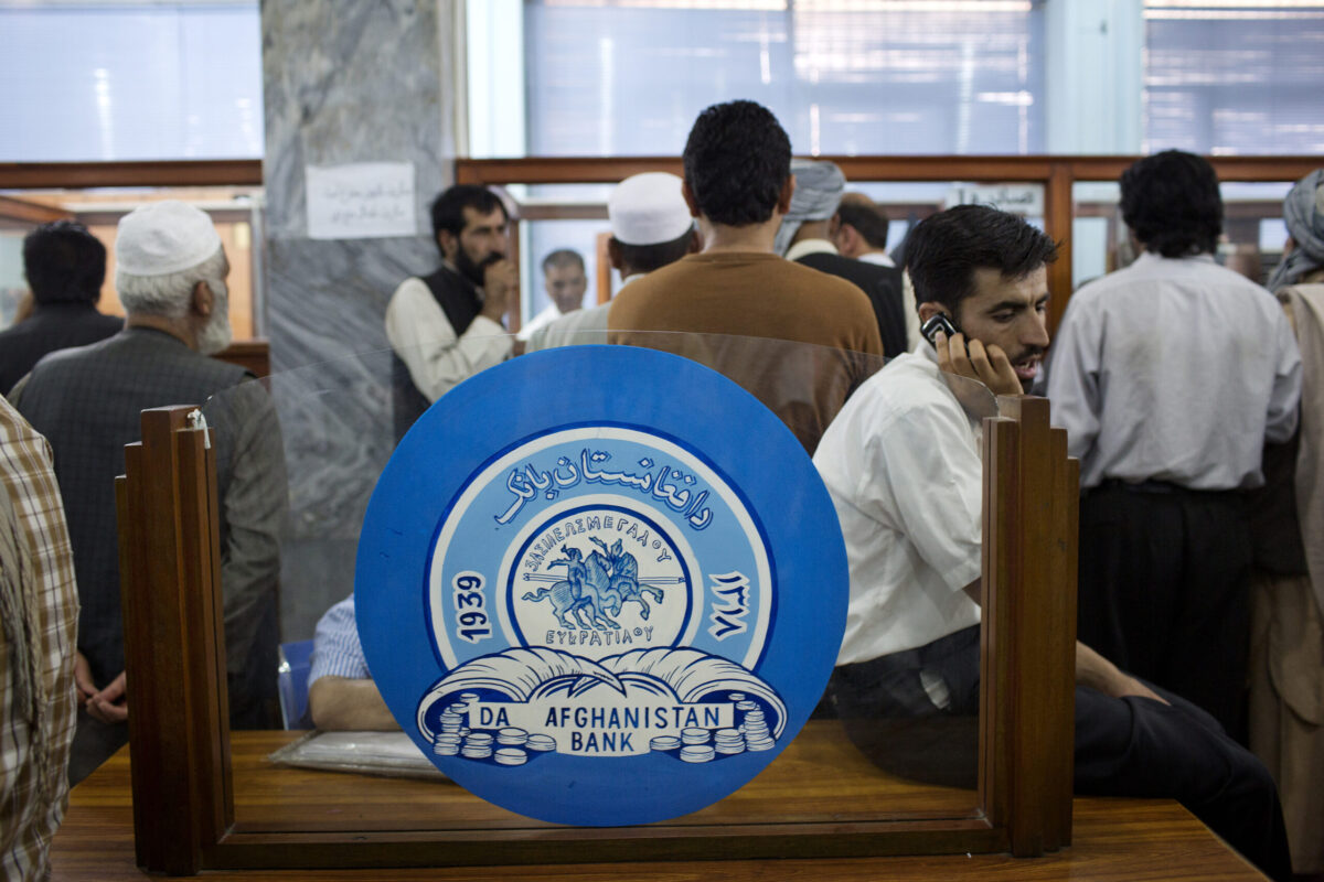 Customers wait to pay government fees at the headquarters of the Da Afghanistan Bank, Afghanistan's central bank, in Kabul, Afghanistan [Victor J. Blue/Bloomberg via Getty Images]